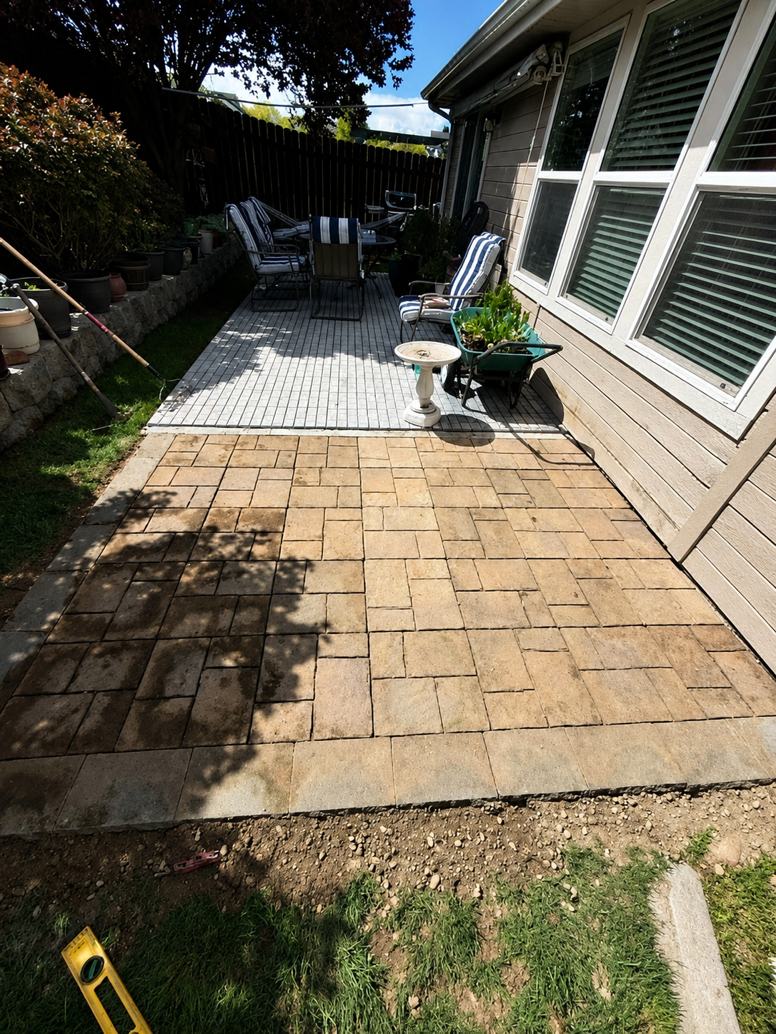 Paver patio installation with stone pavers and mosaic tile area